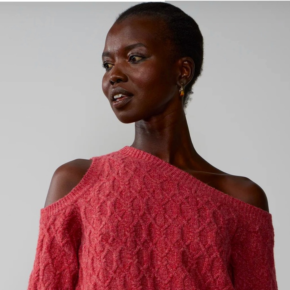 Show that skin Sis. Sexy, cutout shoulder long sleeve cable knit sweater.